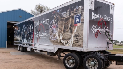 Professional applying vinyl graphic wrap to a truck